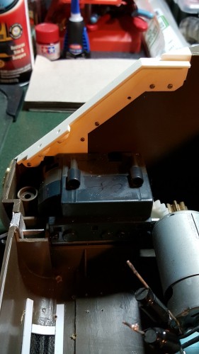 Five brass bolts hold the spacers securely. A sixth was unneeded and would have stressed the plastic.  Extra thread length was snipped off and filed.