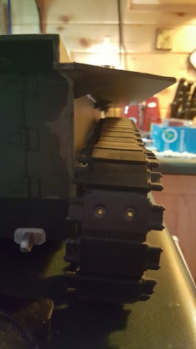 I have the bottom of the tracks pulled to the side slightly but it can be seen that the top run lays flat over the return rollers now.