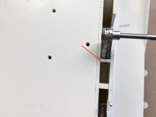 Arm travel limiter indicated by red arrow
