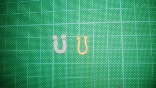 Plastic shackle in production and brass shackle