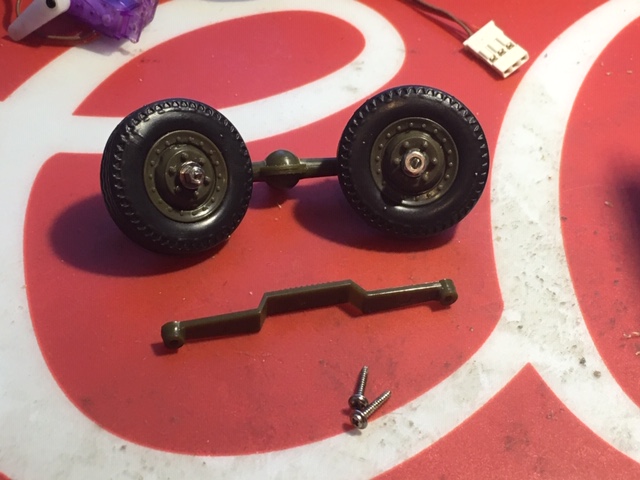 The front wheels have been replaced because they would not roll and they were plastic. These are wheels from a 1/35 M3 Half Track. mounted to stock axle with small screws and nuts, steel axles.
