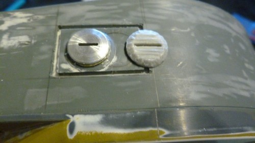 Early vision plug left and later wider vision slot on right.